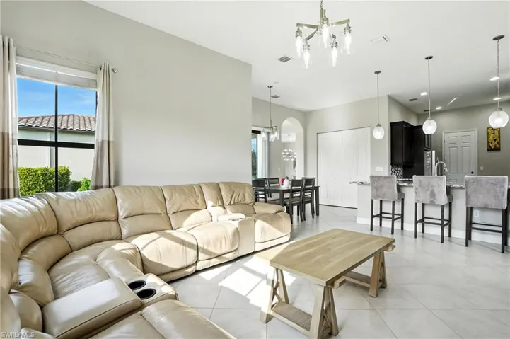 Living room featuring a chandelier, plenty of natural light, and light tile patterned floors