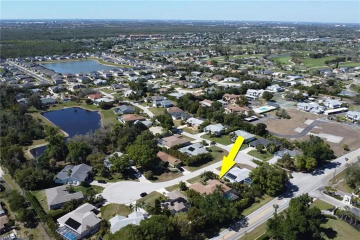 Aerial view of property's location featuring nearby suburban area and a large body of water
