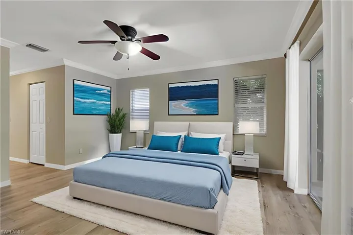 Bedroom featuring ceiling fan, light wood-style floors, and ornamental molding