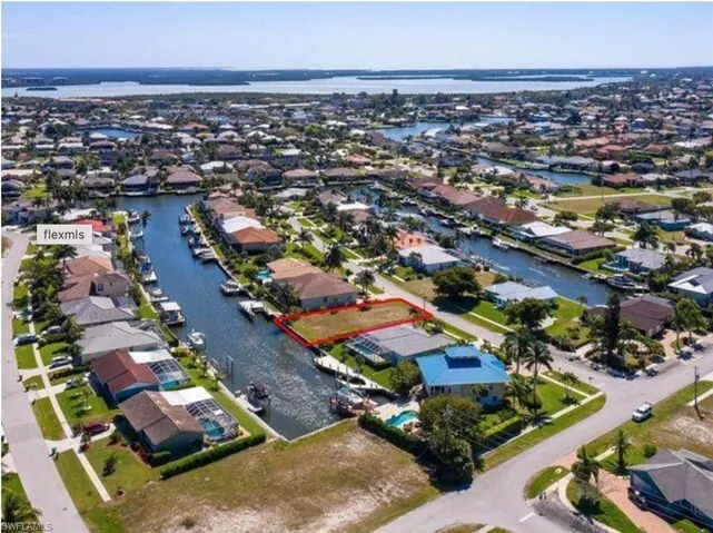 View of property location with nearby suburban area, property boundaries highlighted, and a large body of water