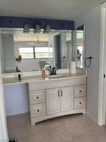 Bathroom featuring tile floors, ceiling fan, and oversized vanity