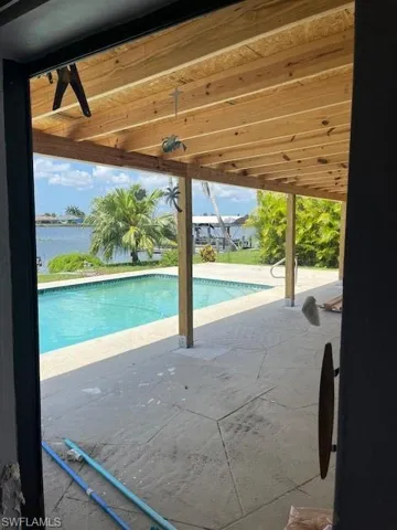 View of pool featuring a patio and ceiling fan