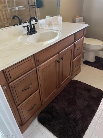 Bathroom with tile floors, toilet, and vanity