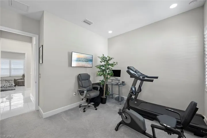 Exercise area featuring baseboards, carpet floors, visible vents, and recessed lighting