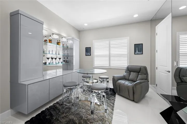 Bar featuring baseboards, a dry bar, tile patterned floors, and recessed lighting