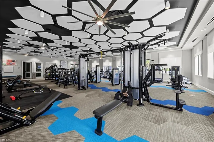 Exercise room featuring carpet, baseboards, and visible vents