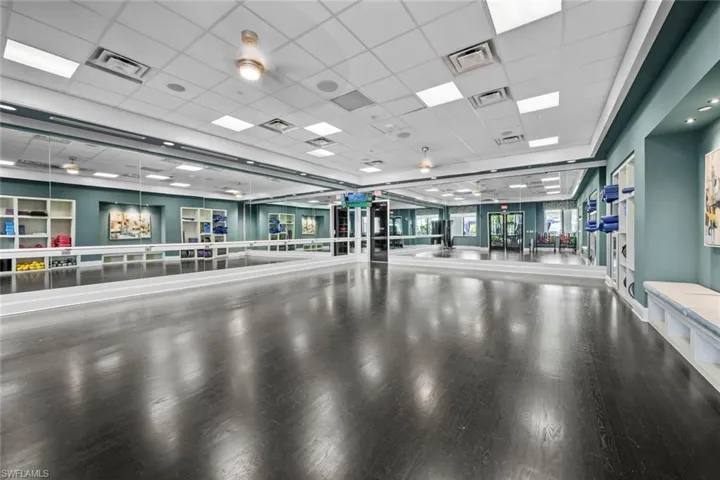 Workout area featuring visible vents and wood finished floors