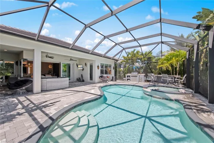 View of pool featuring an outdoor living space, a pool with connected hot tub, a patio, and a ceiling fan