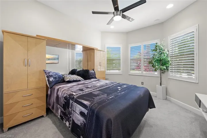 Bedroom featuring light carpet, baseboards, recessed lighting, and a ceiling fan