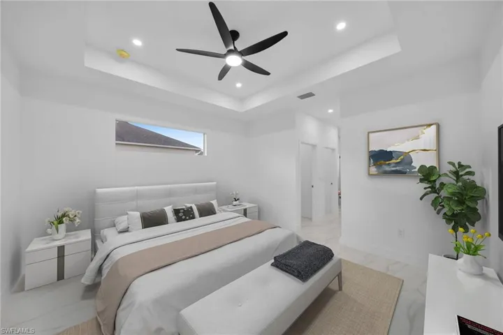 Virtually Staging Bedroom featuring ceiling fan and a tray ceiling