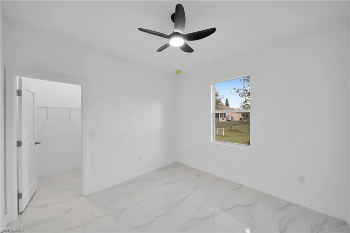 Empty room featuring ceiling fan