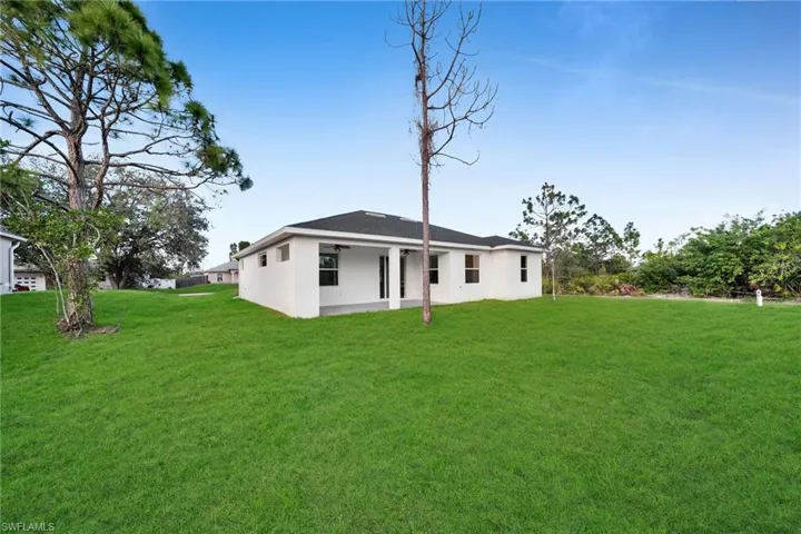 Back of house featuring a lawn