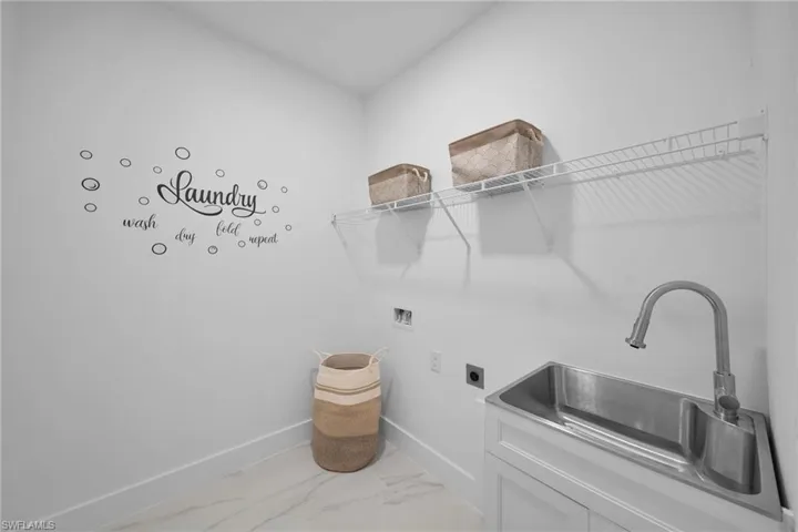 Virtually Staging Laundry room with washer hookup, sink, electric dryer hookup, and cabinets