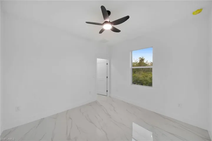 Unfurnished room featuring ceiling fan