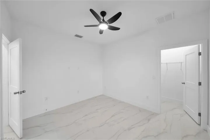 Spare room with ceiling fan
