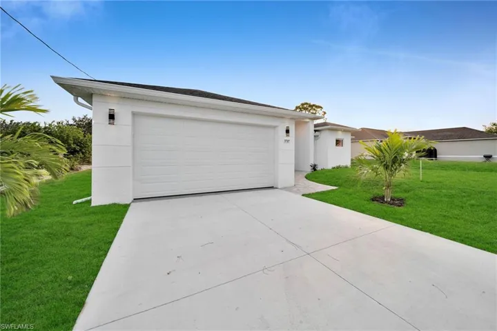 Single story home featuring a front lawn and a garage