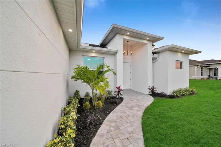 Doorway to property with a yard