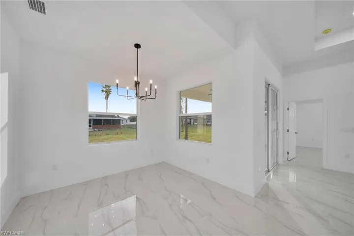 Unfurnished dining area featuring a notable chandelier
