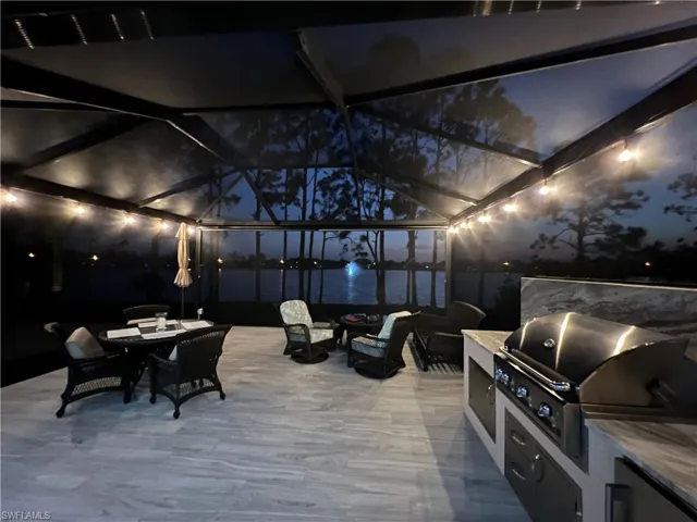 View of patio / terrace with a lanai, a sunroom, and an outdoor kitchen / dining area