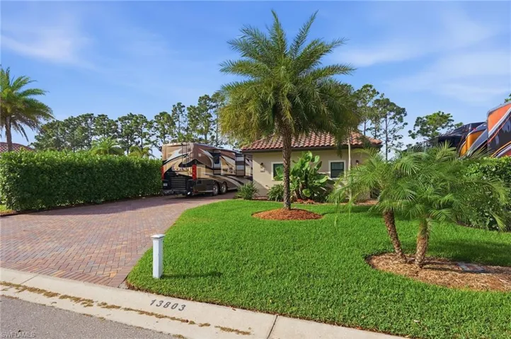 Mediterranean / spanish-style home featuring a front lawn, stucco siding, and a tile roof
