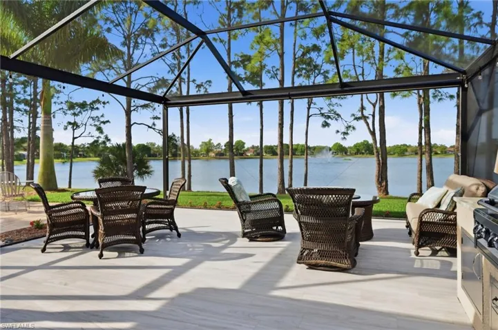 View of patio / terrace with a lanai, a sunroom, a water view, and outdoor lounge area