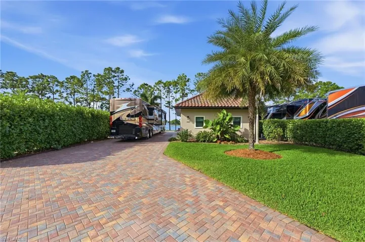 Mediterranean / spanish home featuring a front yard, stucco siding, decorative driveway, and a tile roof