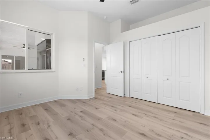 Unfurnished bedroom featuring a closet and light wood-type flooring