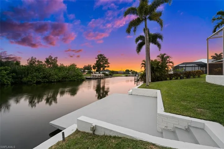Dock area featuring a yard and a water view
