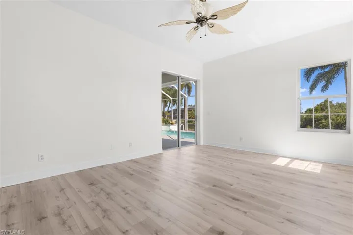 Unfurnished room with ceiling fan and light hardwood / wood-style flooring