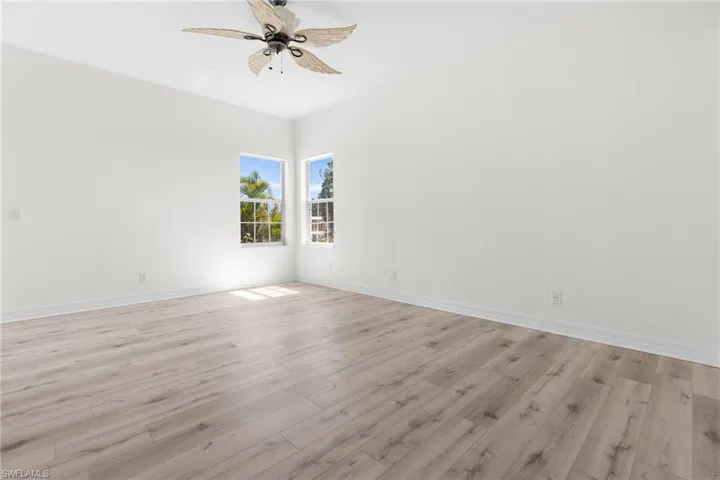 Unfurnished room featuring ceiling fan and light hardwood / wood-style flooring