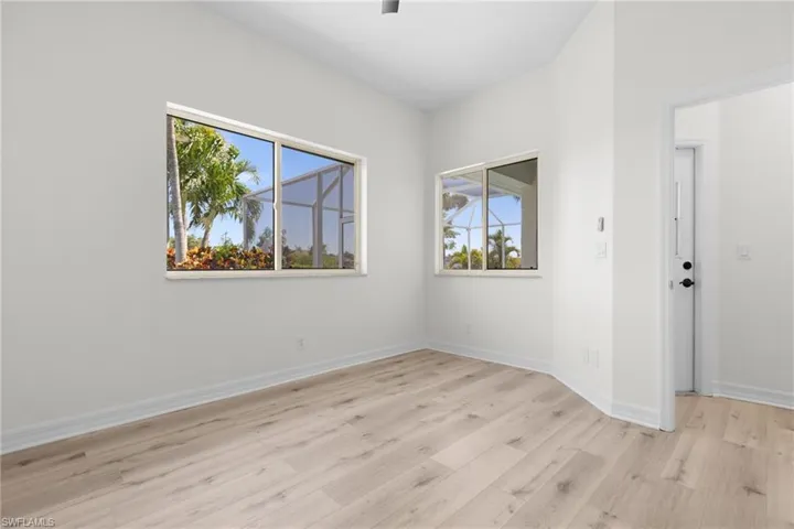 Empty room with light hardwood / wood-style floors and plenty of natural light