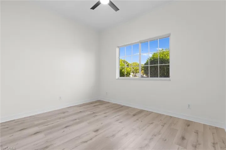 Unfurnished room featuring ceiling fan and light hardwood / wood-style flooring
