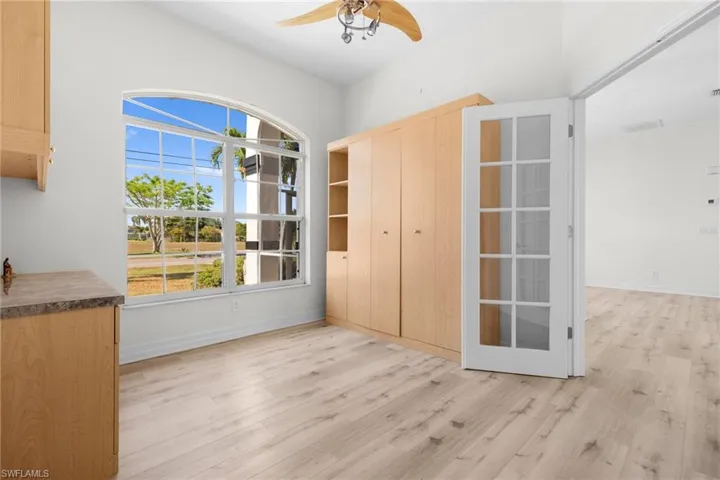 Unfurnished room with ceiling fan and light hardwood / wood-style flooring