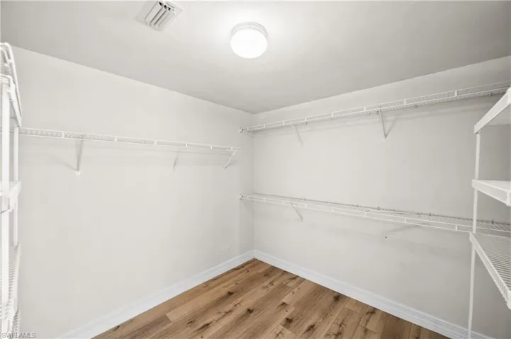 Spacious closet featuring light wood-type flooring