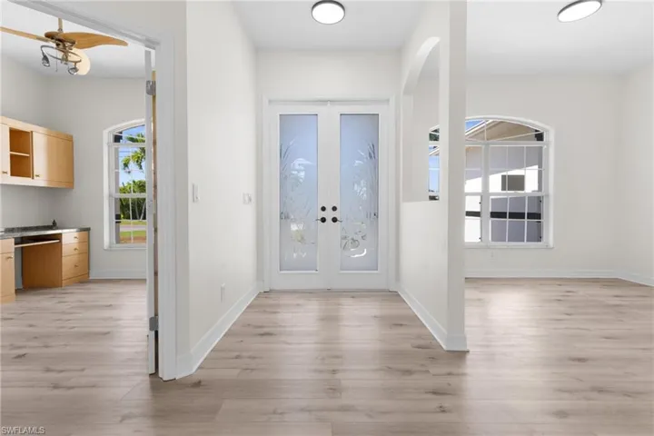 Entrance foyer with french doors and light wood-type flooring