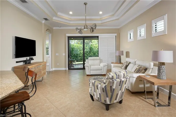 Beautiful and spacious open floor-plan! Notice the ceiling detail and plantation shutters.