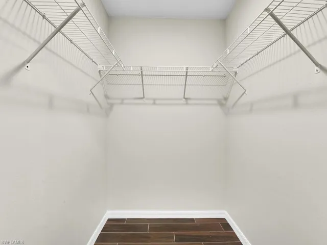 Spacious closet featuring hardwood / wood-style flooring