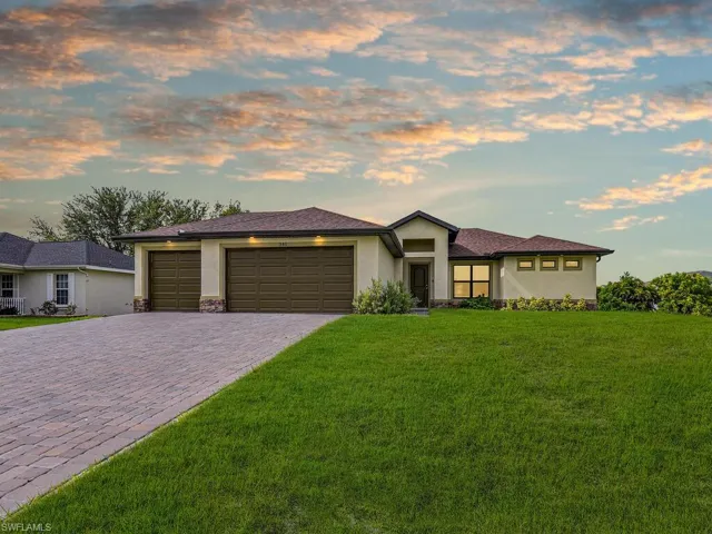 Prairie-style house featuring a garage and a yard