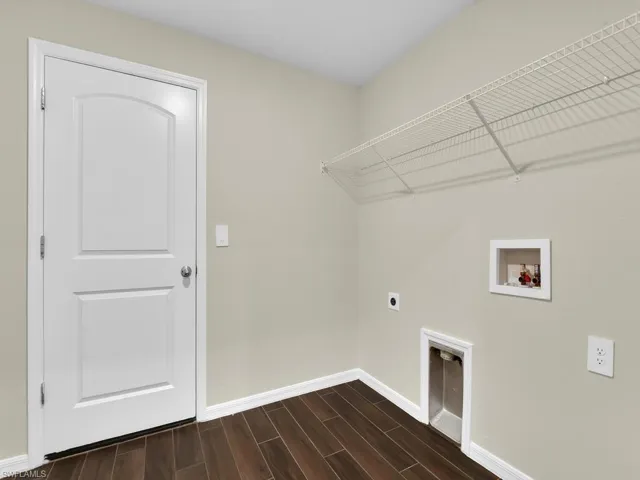 Laundry room featuring hookup for an electric dryer, hardwood / wood-style floors, and washer hookup