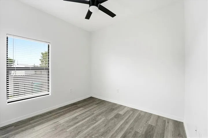 Spare room featuring light wood-style flooring and a ceiling fan