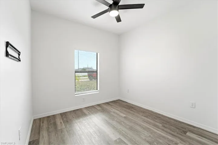 Empty room featuring light wood-type flooring and ceiling fan