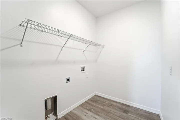 Laundry area with light wood-type flooring, washer hookup, and electric dryer hookup