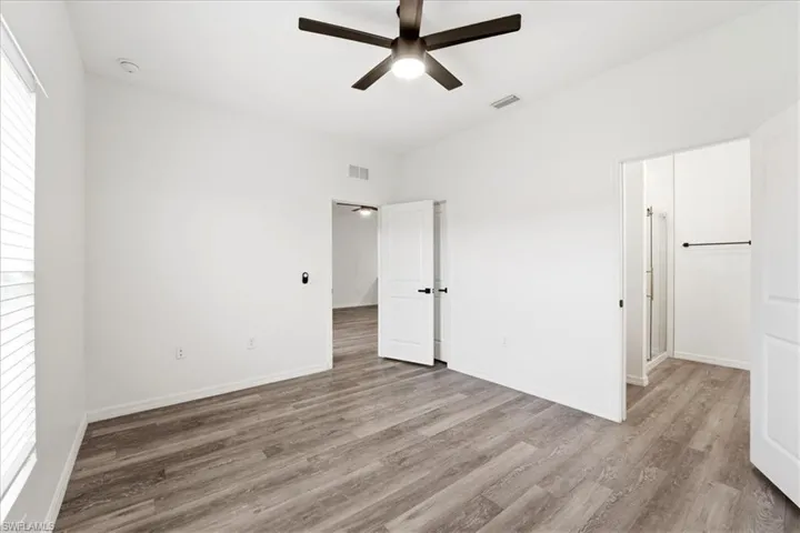 Unfurnished bedroom featuring a ceiling fan and light wood finished floors