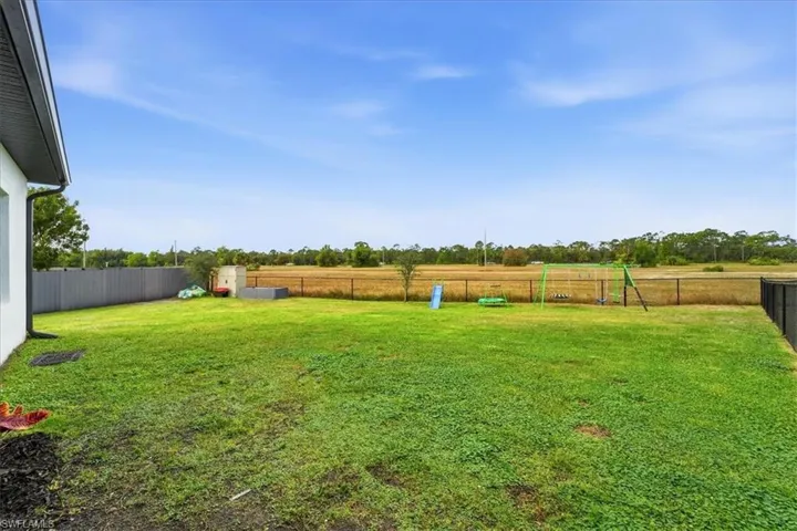 Fenced backyard with a rural view