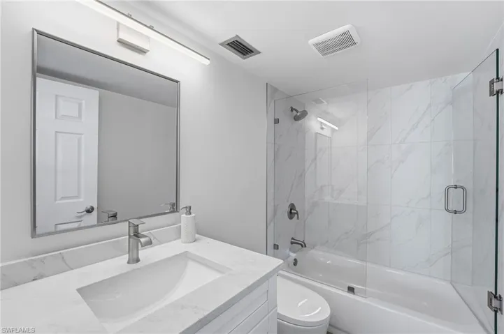 The remodeled primary bath features modern finishes and smart upgrades.
