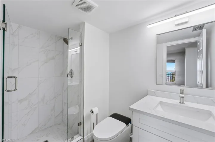 The guest bath has been tastefully remodeled with stylish finishes and smart toilet technology.