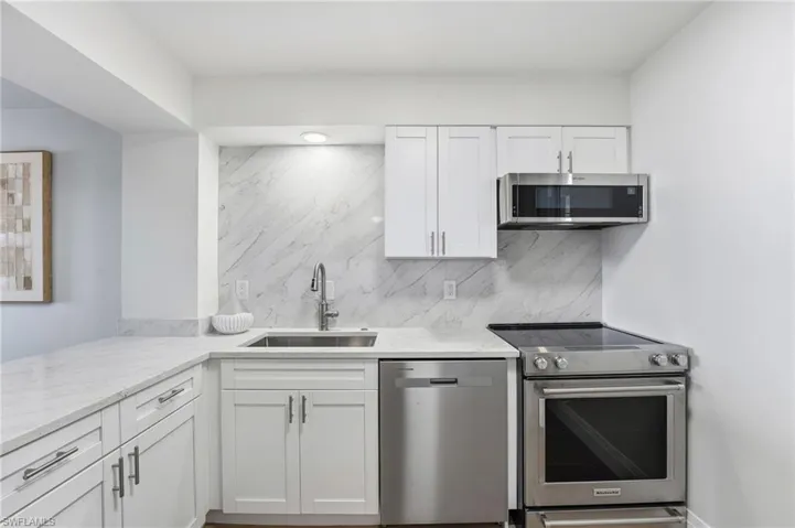 The newly renovated kitchen features new cabinetry and updated appliances for both style and function.