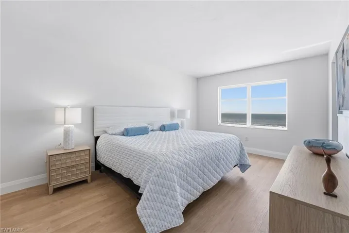 The primary bedroom offers comfort, style, and a peaceful coastal atmosphere.