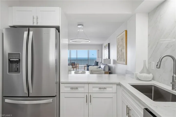The newly renovated kitchen features new cabinetry and updated appliances for both style and function.