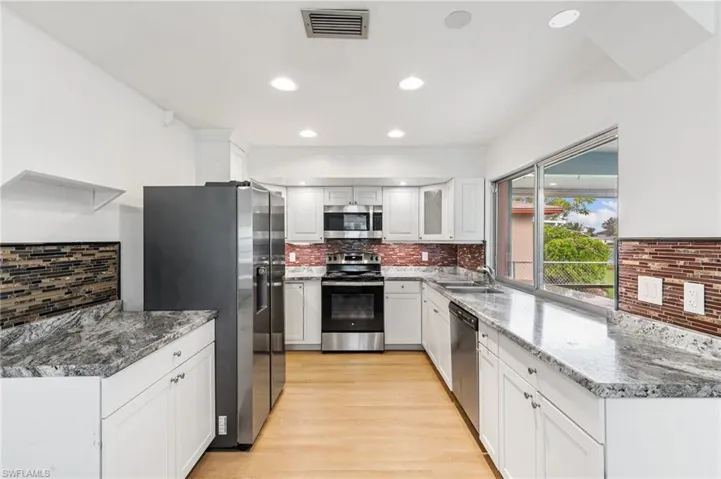 Kitchen with pass through sliding window to outdoor kitchen